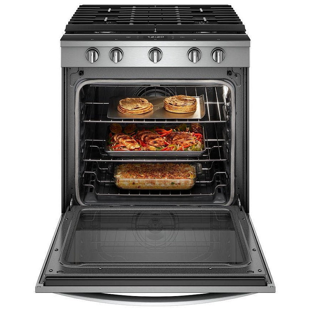 A variety of dishes cooking on the gas burners of the stove, with sizzling pots and pans on the cooktop.